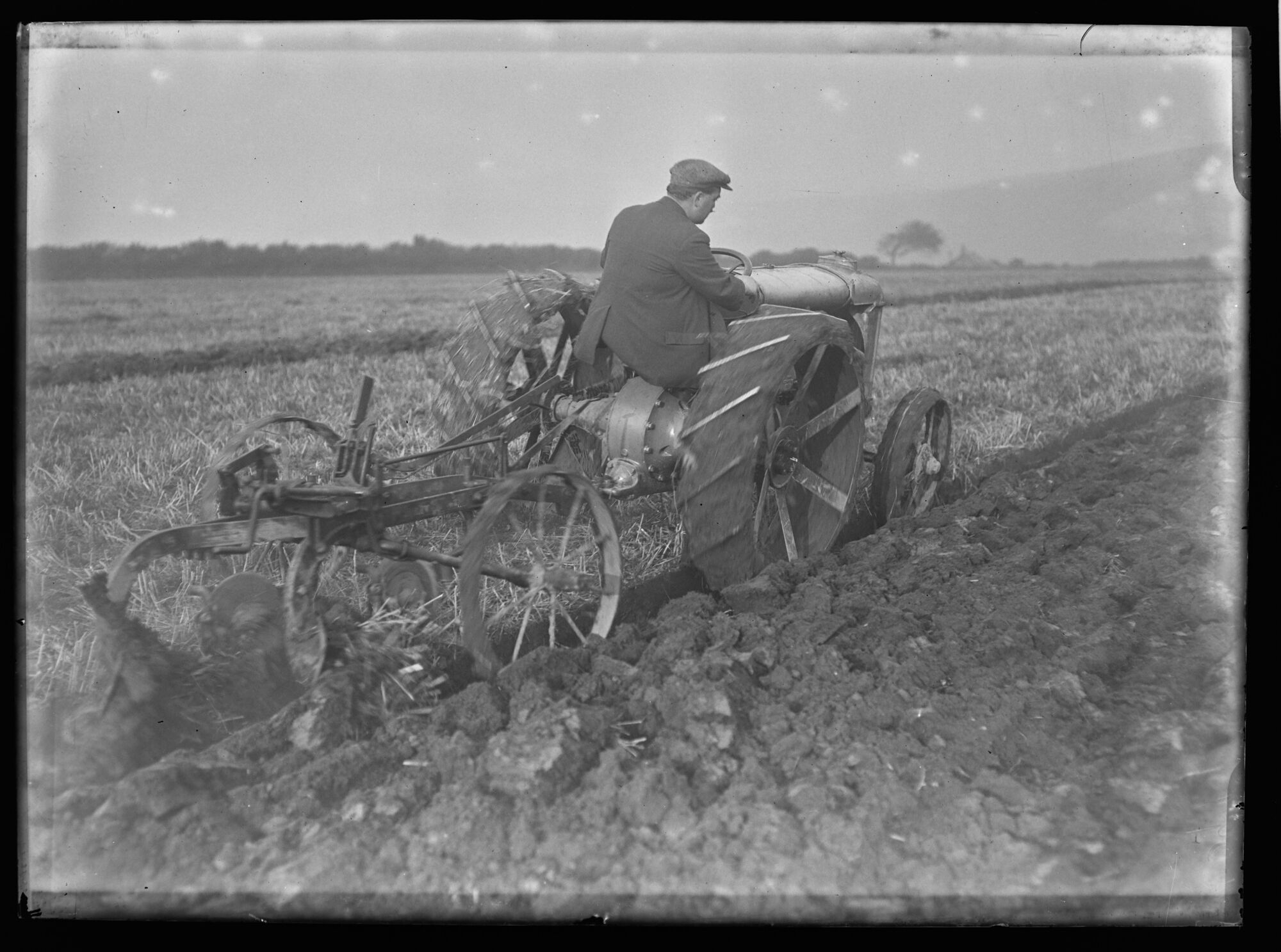 Plowing with an early tractor, as they began to supplant horses